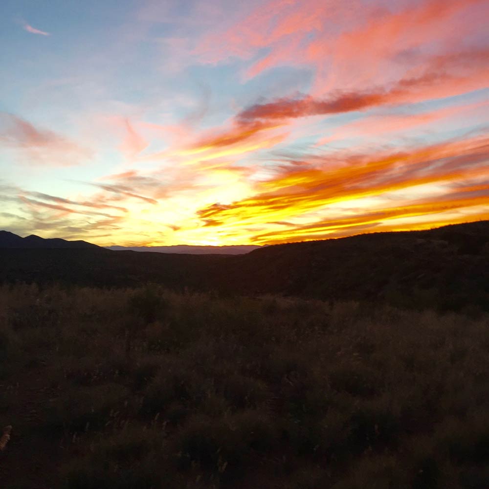 a fiery sunset on the Geronimo Trail National Scenic Byway